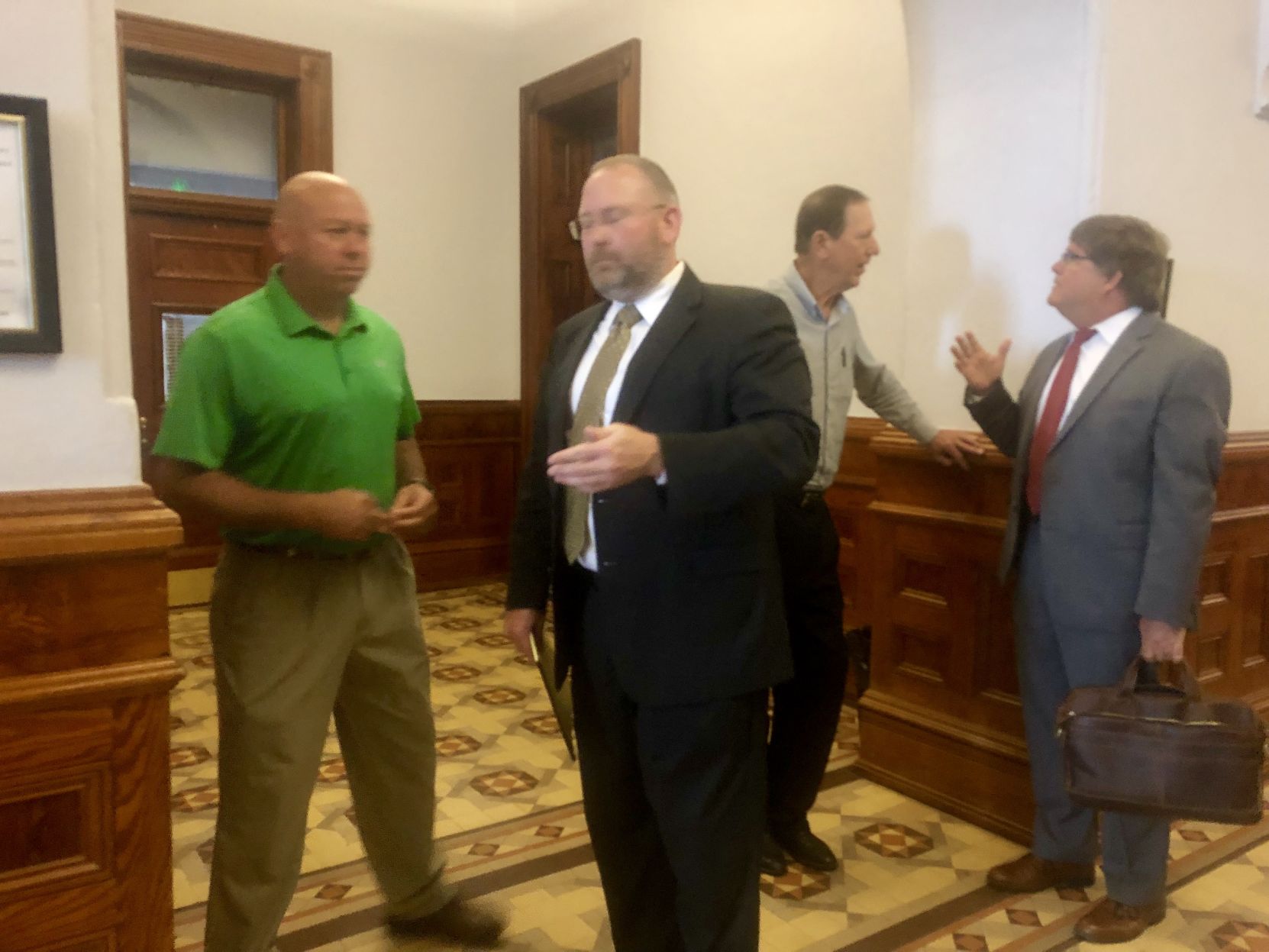 Hallettsville high assistant principal Scott Cottenoir talks with his attorney